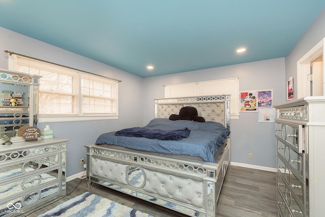 bedroom with dark hardwood / wood-style floors