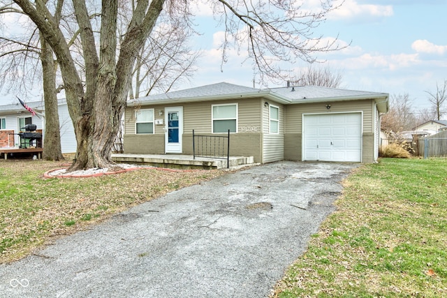 view of front of house with a garage and a front yard