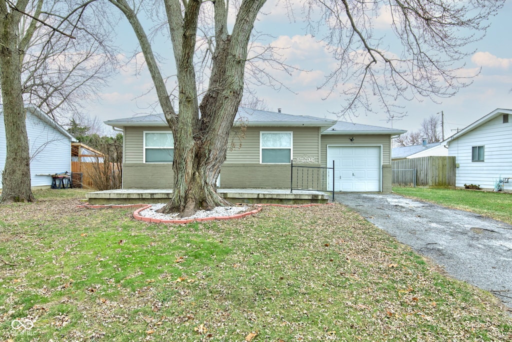 view of front of house with a front yard and a garage