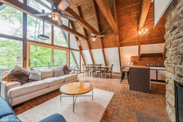 living room featuring high vaulted ceiling and a healthy amount of sunlight