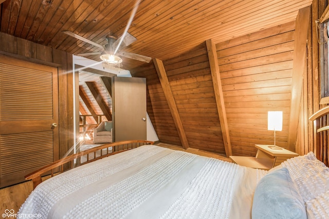 bedroom featuring wooden walls, ceiling fan, and wood ceiling