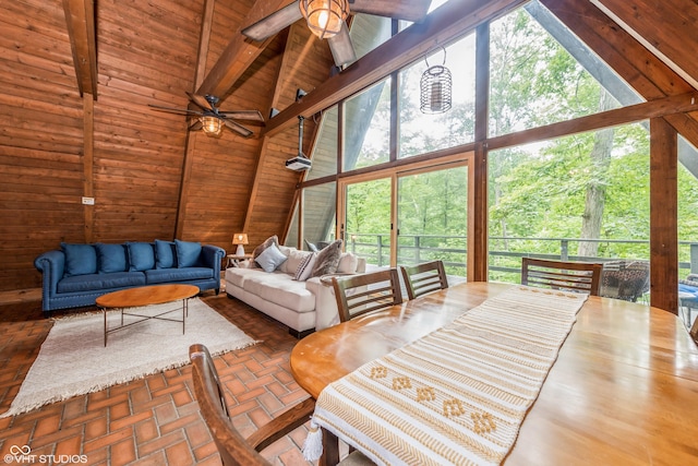 sunroom / solarium featuring wood ceiling, plenty of natural light, and lofted ceiling with beams