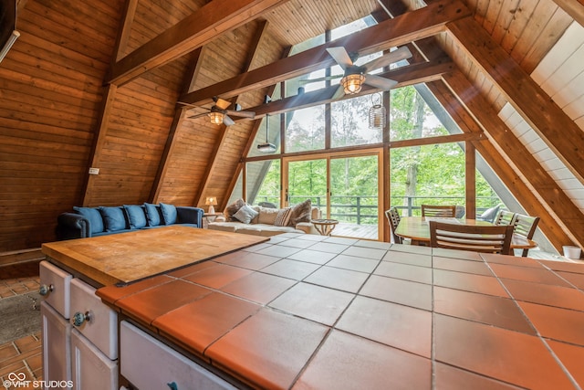 bedroom with vaulted ceiling with skylight and multiple windows