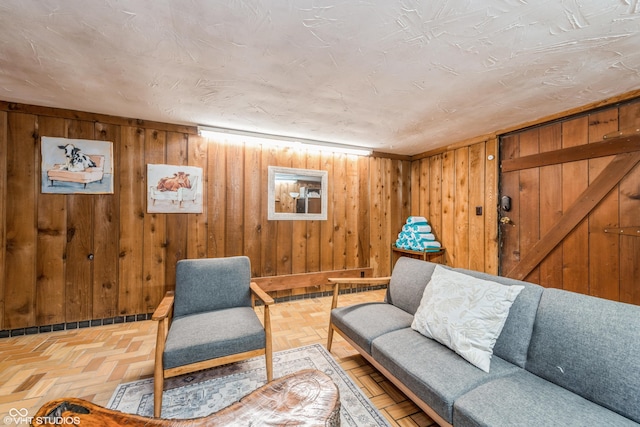 living area featuring wood walls and parquet floors