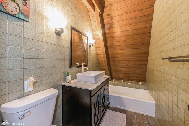 bathroom with vanity, a washtub, toilet, tile walls, and wood-type flooring