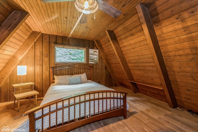 bedroom with hardwood / wood-style flooring, lofted ceiling, wood walls, and wooden ceiling