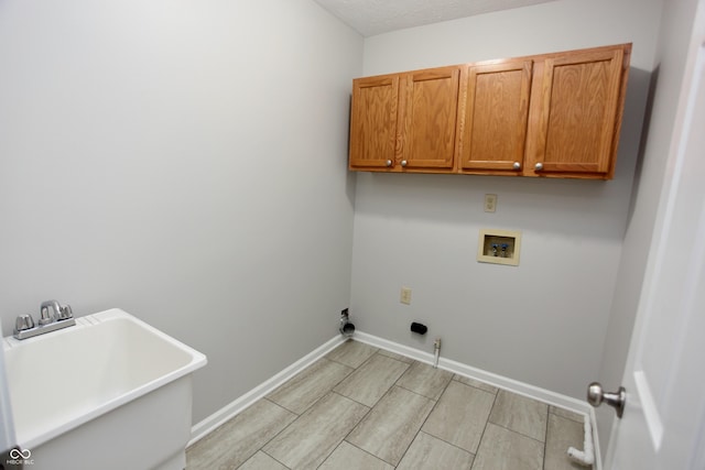 laundry area featuring sink, cabinets, washer hookup, gas dryer hookup, and light wood-type flooring