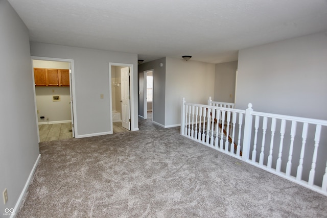 unfurnished room with light carpet