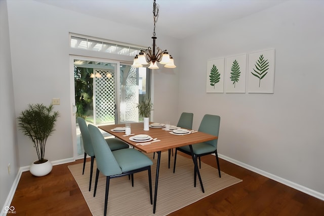 dining area featuring a chandelier and dark wood-type flooring