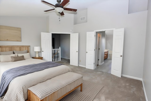 carpeted bedroom featuring high vaulted ceiling and ceiling fan