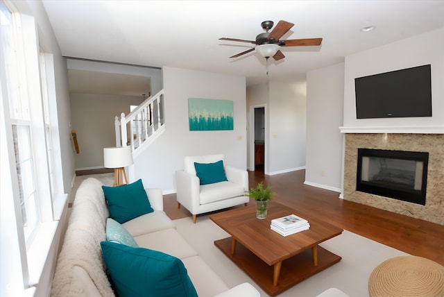 living room with ceiling fan and hardwood / wood-style flooring