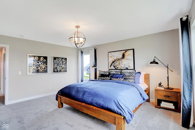 carpeted bedroom featuring a chandelier