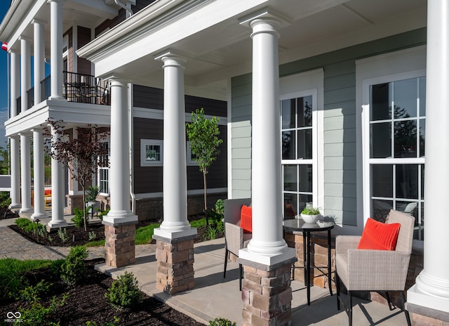 view of patio / terrace featuring a porch and a balcony