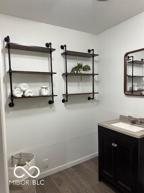 bathroom with hardwood / wood-style floors and vanity