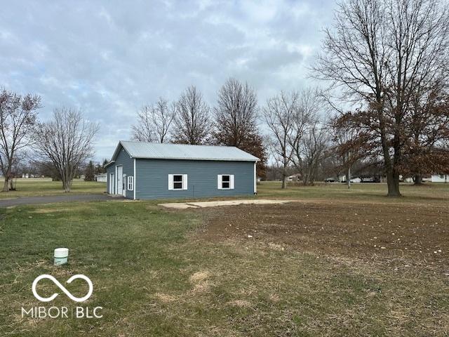 view of side of property featuring an outbuilding