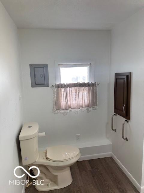 bathroom featuring hardwood / wood-style floors and toilet