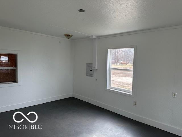 unfurnished room featuring a textured ceiling and crown molding