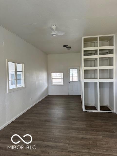 unfurnished room with ceiling fan and dark wood-type flooring