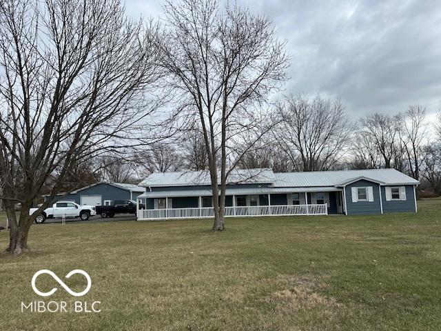 view of front of home with covered porch and a front yard