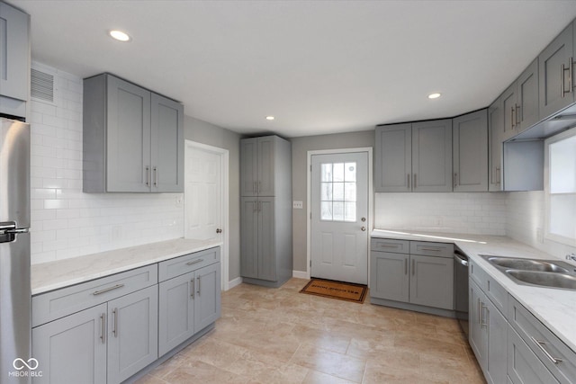 3060 S Shortridge Rd, Indianapolis, IN 46239 - kitchen with gray cabinets, stainless steel appliances, recessed lighting, tasteful backsplash, and light stone countertops