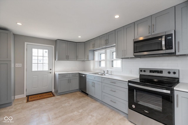 3060 S Shortridge Rd, Indianapolis, IN 46239 - kitchen with stainless steel appliances, gray cabinetry, light countertops, backsplash, and recessed lighting