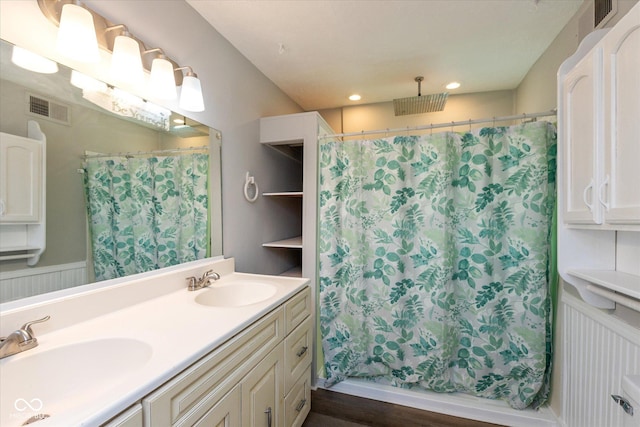 3060 S Shortridge Rd, Indianapolis, IN 46239 - bathroom featuring curtained shower, double vanity, recessed lighting, and wood finished floors