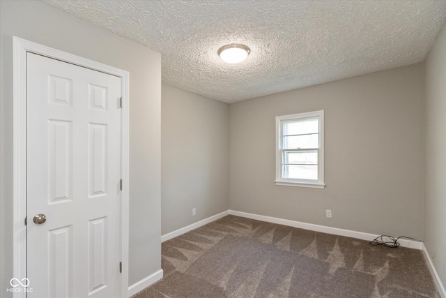 spare room with carpet floors and a textured ceiling