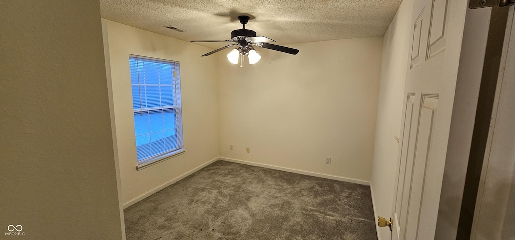 carpeted empty room with a textured ceiling and ceiling fan