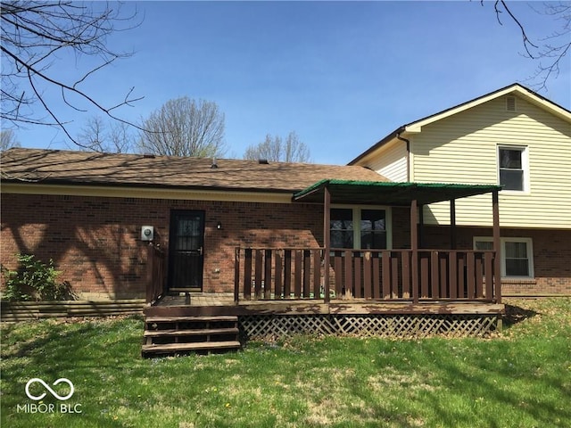 rear view of house featuring a lawn and a deck