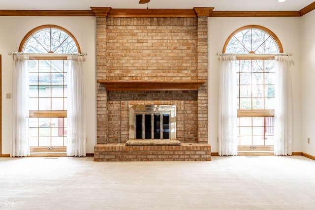 unfurnished living room featuring crown molding, carpet floors, and a fireplace