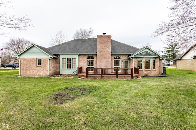 back of property with a wooden deck and a yard