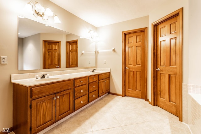 bathroom featuring tiled bath, tile patterned flooring, and vanity