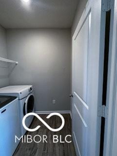 clothes washing area featuring dark wood-type flooring and independent washer and dryer