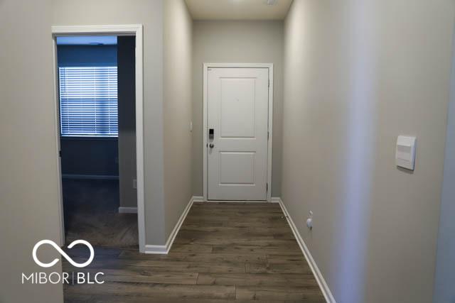 hallway with dark wood-type flooring