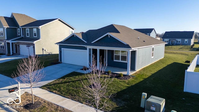 view of property with a garage and a front lawn