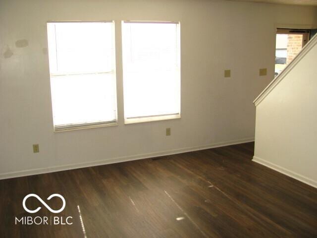 unfurnished room featuring dark wood-type flooring