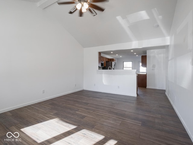 unfurnished living room with ceiling fan, dark hardwood / wood-style flooring, and lofted ceiling with beams