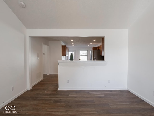 unfurnished room with dark wood-type flooring