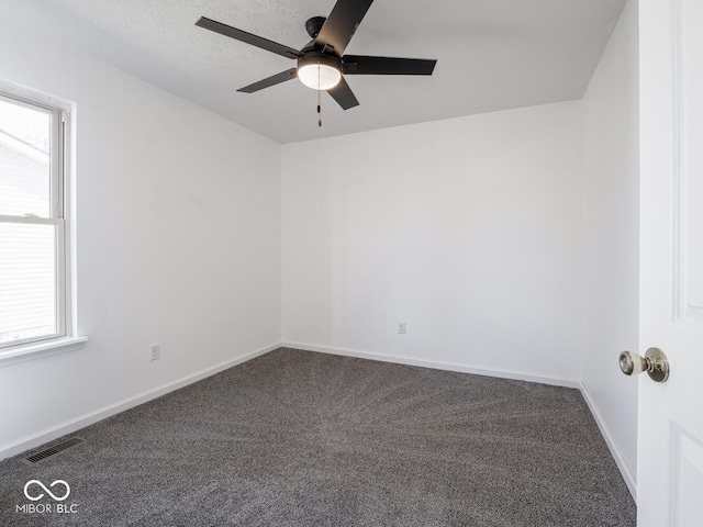 carpeted empty room featuring ceiling fan