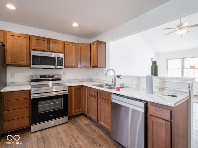 kitchen featuring sink, vaulted ceiling, dark hardwood / wood-style floors, ceiling fan, and appliances with stainless steel finishes