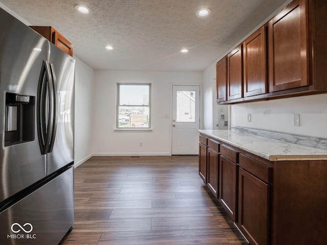 kitchen featuring stainless steel fridge with ice dispenser, a textured ceiling, and dark hardwood / wood-style floors