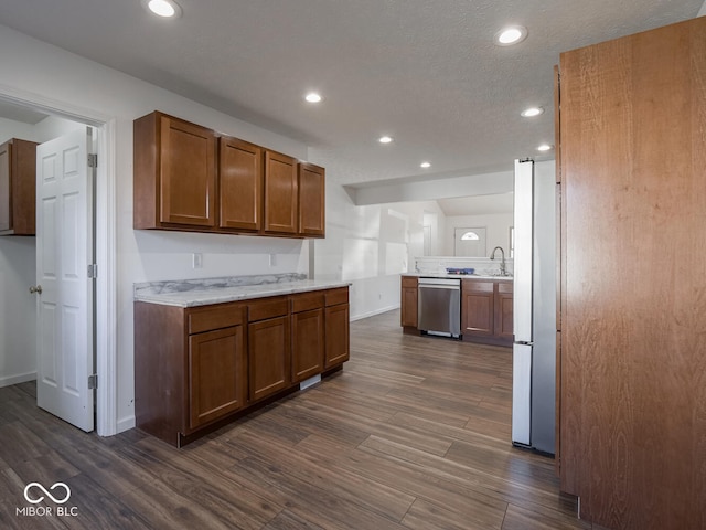 kitchen featuring dishwasher, dark hardwood / wood-style flooring, white fridge, and sink