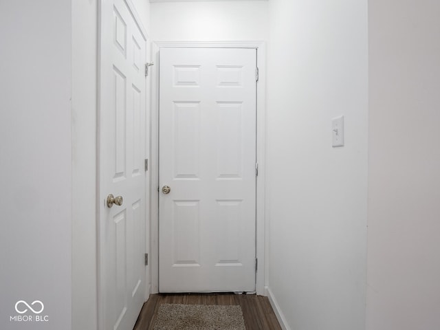 hallway featuring dark hardwood / wood-style flooring