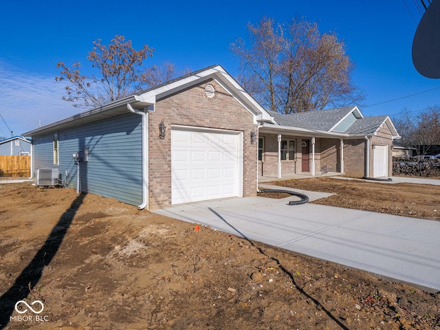 ranch-style house with cooling unit and a garage