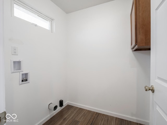 washroom with hookup for a washing machine, dark hardwood / wood-style flooring, and cabinets