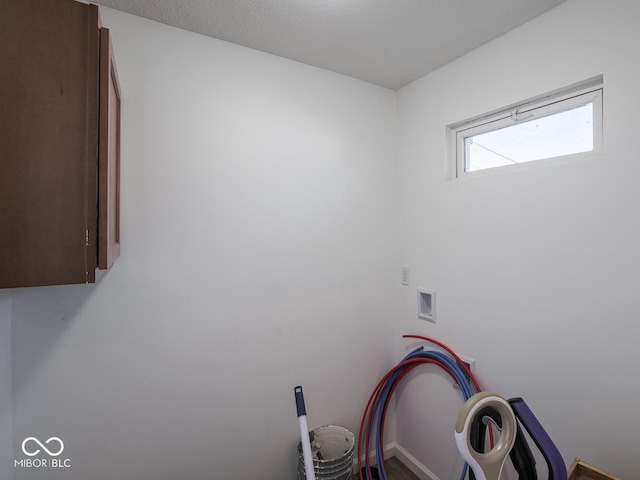 clothes washing area featuring cabinets and hookup for a washing machine