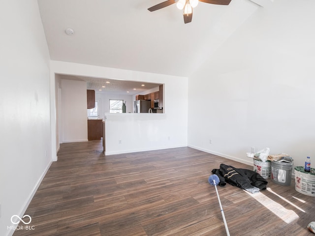 unfurnished living room featuring dark hardwood / wood-style flooring, high vaulted ceiling, and ceiling fan