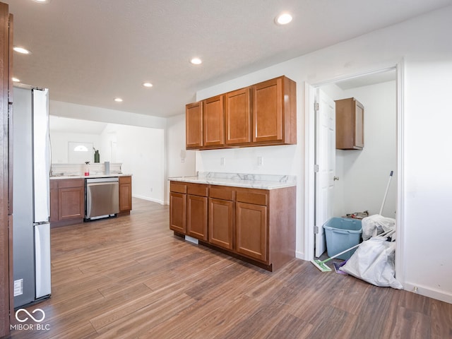 kitchen featuring hardwood / wood-style flooring and appliances with stainless steel finishes