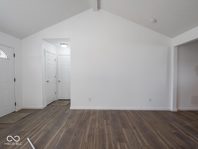 entrance foyer with lofted ceiling with beams and dark wood-type flooring