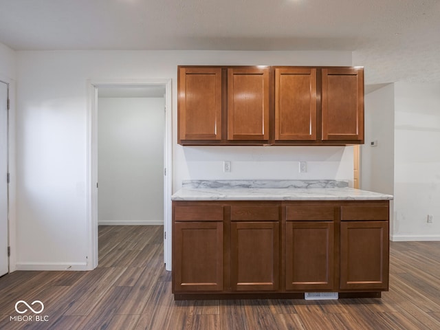 kitchen with dark hardwood / wood-style flooring